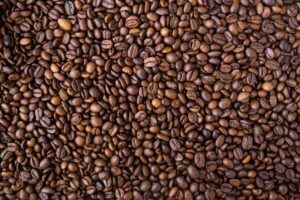A detailed view of medium roast coffee beans, rich in texture and color.