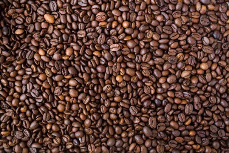 A detailed view of medium roast coffee beans, rich in texture and color.
